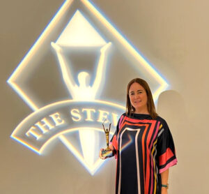 Image of Marian Merino receiving the Gold Stevie award for Innovative Achievement in Human Resources